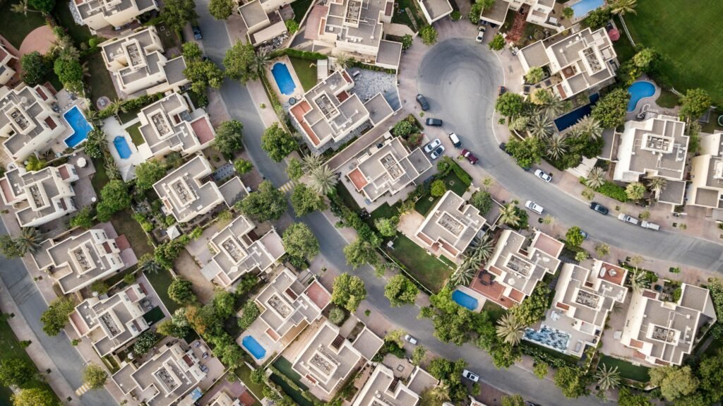 pexels photo 1642125 1642125 Explore a stunning aerial view of a residential area in Dubai with lush greenery and swimming pools.